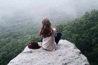 woman looking over cliff